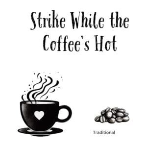 White ceramic mug with black text reading Strike While the Coffee's Hot in clean, bold typography