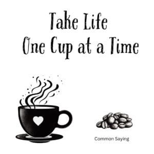 White ceramic coffee mug with black text reading Take Life One Cup at a Time in modern typography