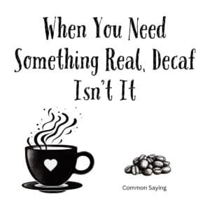 White ceramic coffee mug with quote When You Need Something Real Decaf Isn't It printed in black text