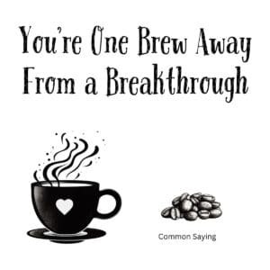 White ceramic coffee mug with black text reading You're One Brew Away From a Breakthrough